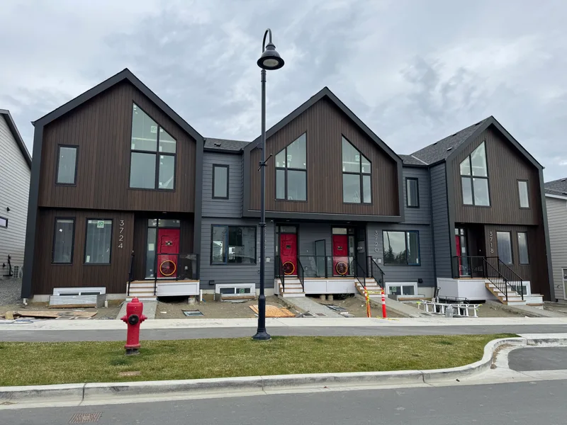 Townhome row with RetroTec blower door fans installed in every front door